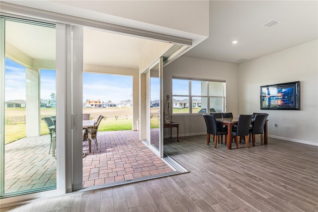 doorway with hardwood / wood-style flooring