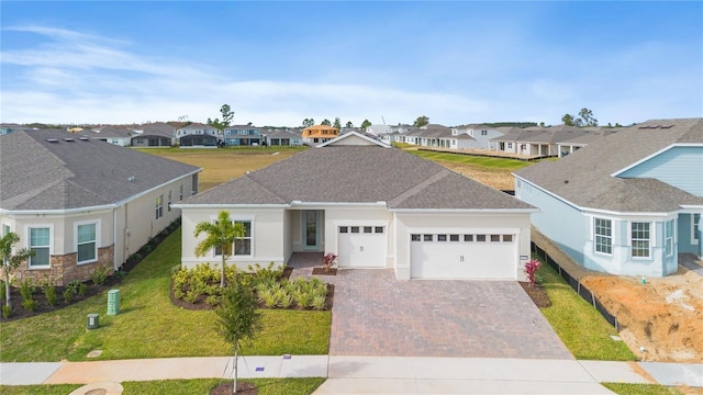 single story home featuring a garage and a front lawn