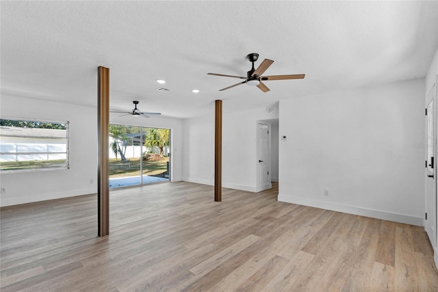 interior space featuring ceiling fan, a textured ceiling, and light hardwood / wood-style flooring