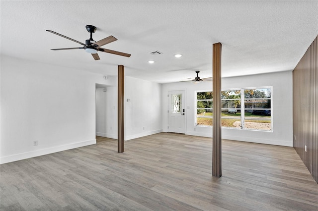 unfurnished living room with ceiling fan and light hardwood / wood-style flooring