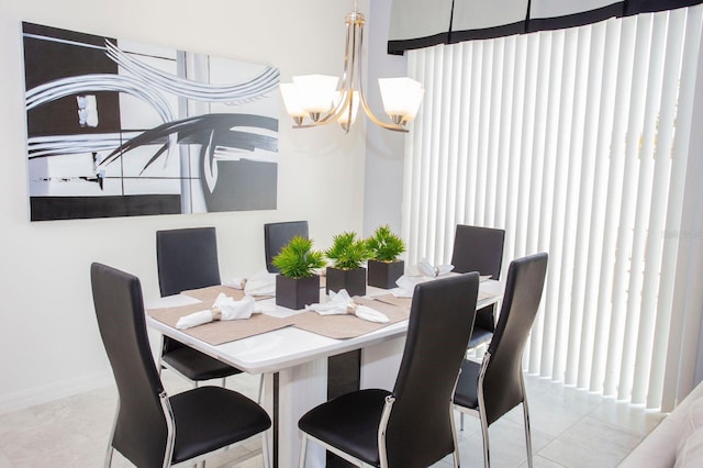 dining room with light tile patterned floors and a notable chandelier