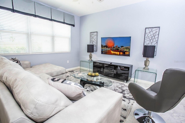 living room featuring ceiling fan and a wealth of natural light