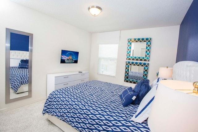 bedroom with carpet and a textured ceiling