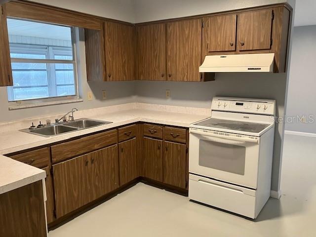 kitchen with sink, dark brown cabinets, and white range with electric cooktop