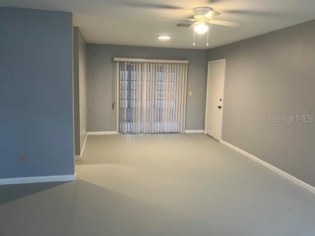 spare room featuring ceiling fan and concrete flooring