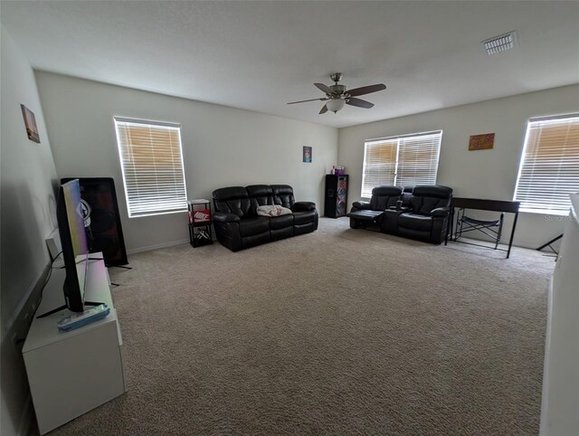 living room featuring ceiling fan and carpet