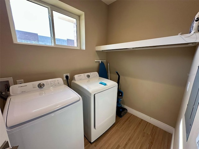 washroom featuring washing machine and dryer and light wood-type flooring