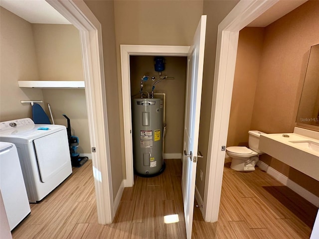 laundry area with water heater and washer and dryer