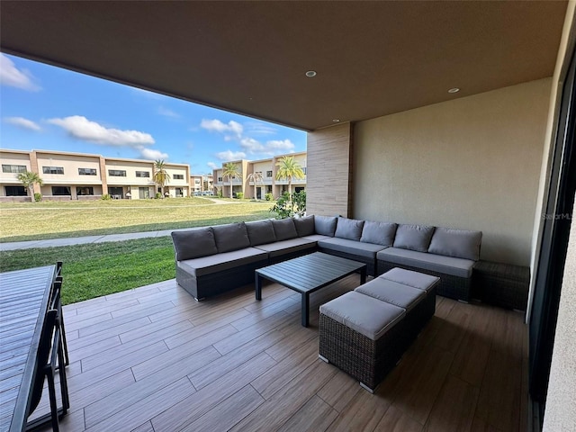 wooden deck featuring outdoor lounge area, a patio area, and a yard