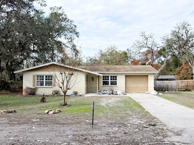 ranch-style home with a front yard and a garage