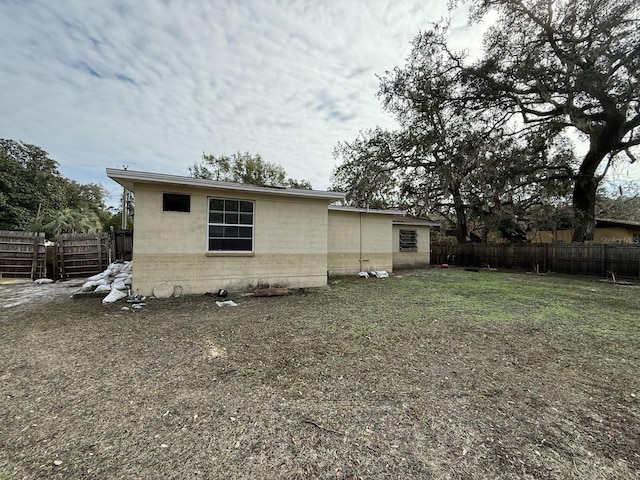 back of property with a lawn