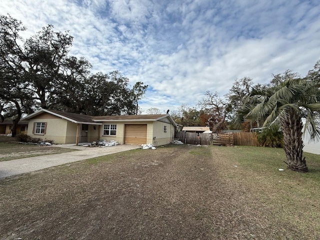 view of front of home featuring a garage and a front lawn