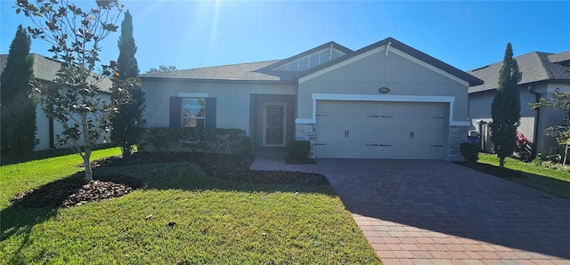 view of front of house featuring a garage and a front lawn