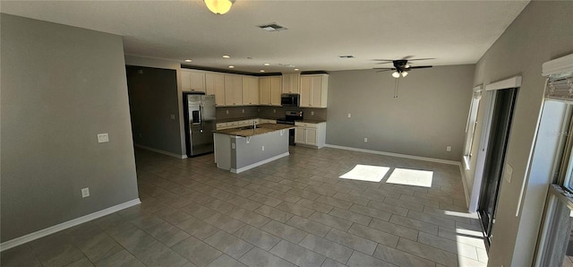 kitchen featuring stainless steel appliances, ceiling fan, sink, white cabinetry, and a kitchen island