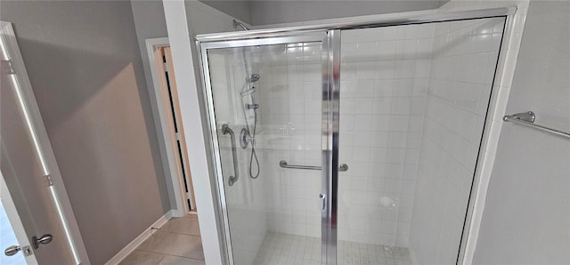 bathroom featuring tile patterned floors and a shower with shower door