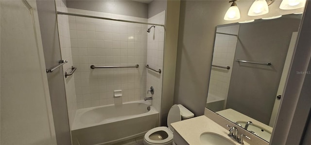 full bathroom featuring vanity, tiled shower / bath combo, and toilet