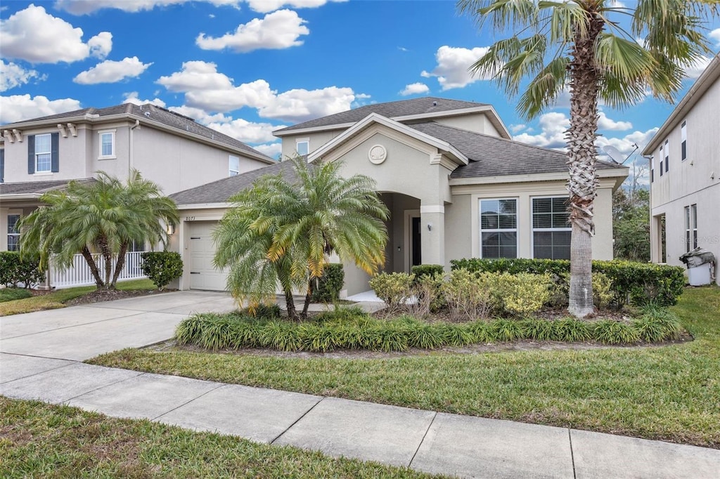 view of front of home with a front lawn and a garage