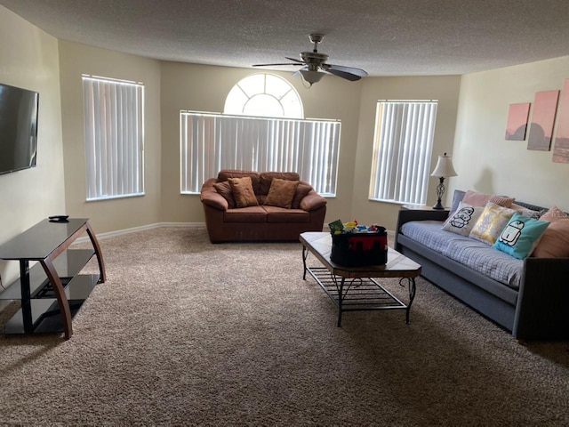 living room featuring carpet flooring, ceiling fan, and a textured ceiling