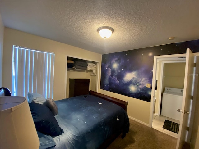 bedroom with washer / clothes dryer, a closet, carpet floors, and a textured ceiling