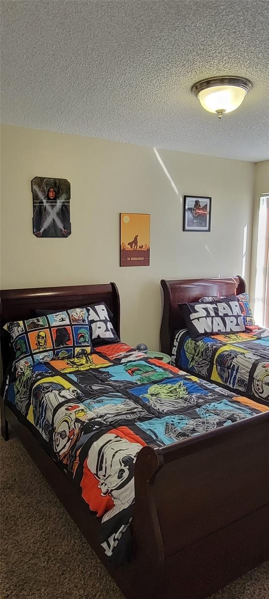 carpeted bedroom featuring a textured ceiling