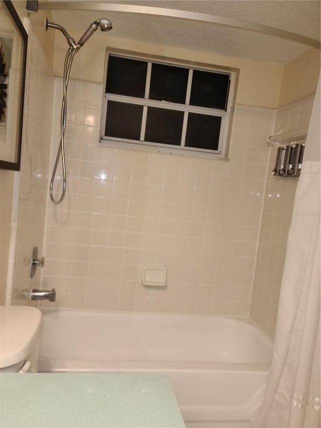 bathroom with shower / tub combo and toilet