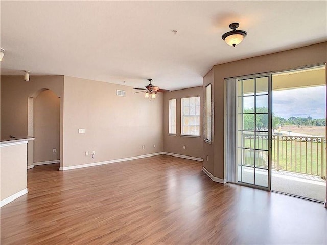 unfurnished living room with ceiling fan and wood-type flooring