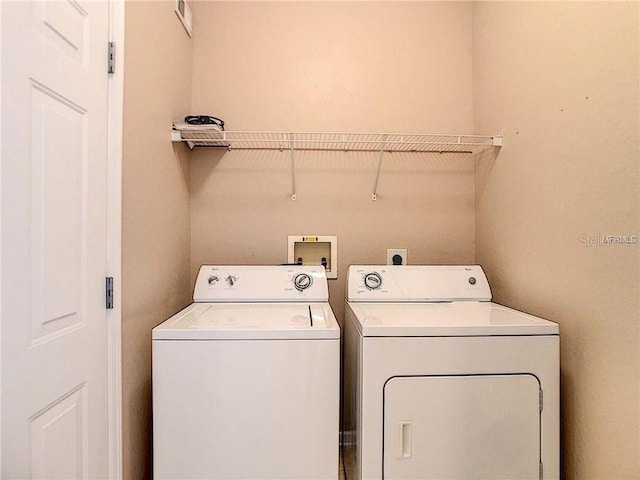 laundry room with separate washer and dryer