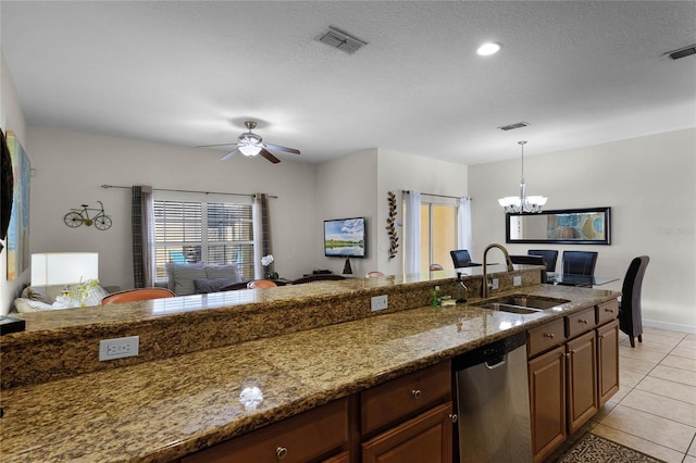 kitchen with sink, light stone counters, stainless steel dishwasher, light tile patterned flooring, and ceiling fan with notable chandelier