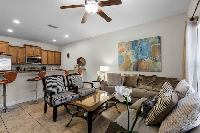 living room with ceiling fan and light tile patterned flooring