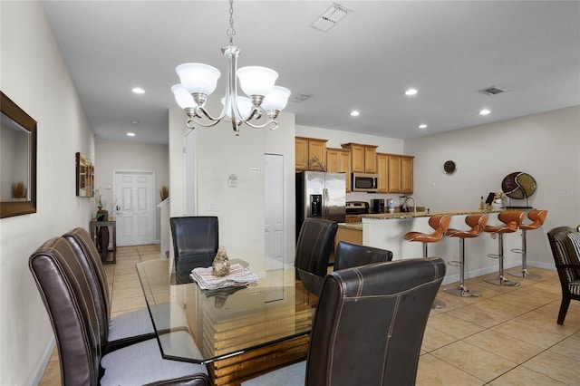 dining room featuring light tile patterned floors and a chandelier