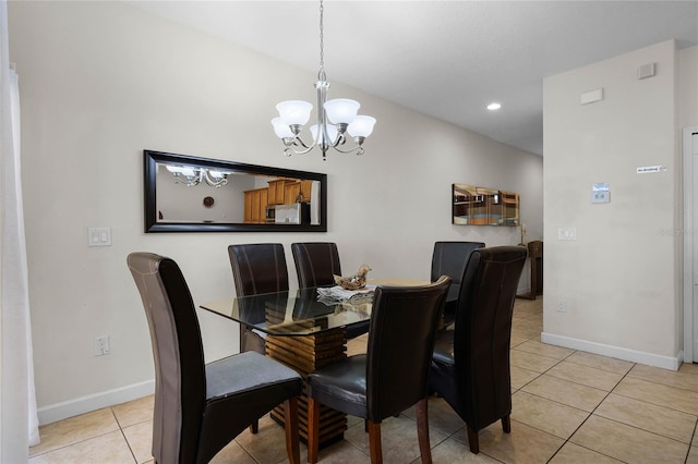 dining space featuring light tile patterned floors and a chandelier