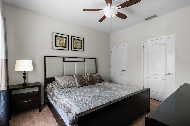 bedroom featuring ceiling fan and dark carpet