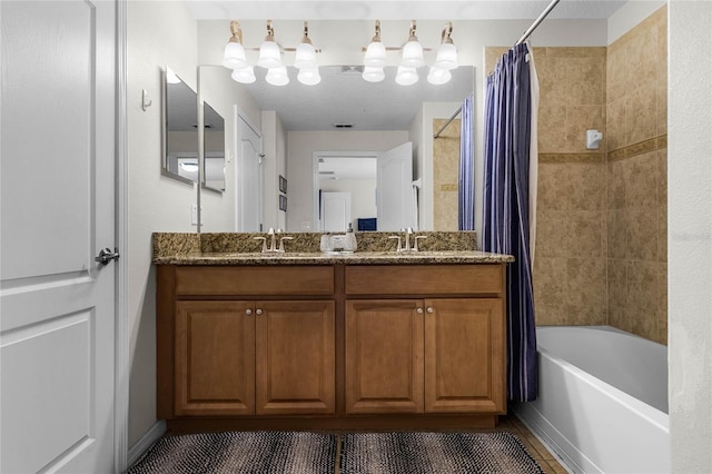 bathroom featuring shower / bathtub combination with curtain, vanity, and tile patterned floors