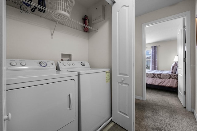 clothes washing area with separate washer and dryer and carpet floors