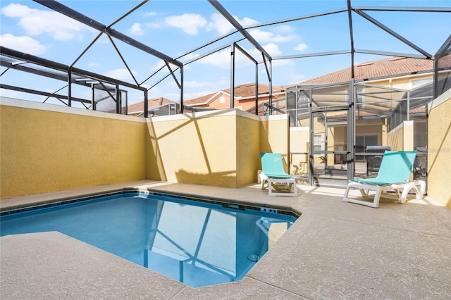 view of swimming pool with a lanai and a patio