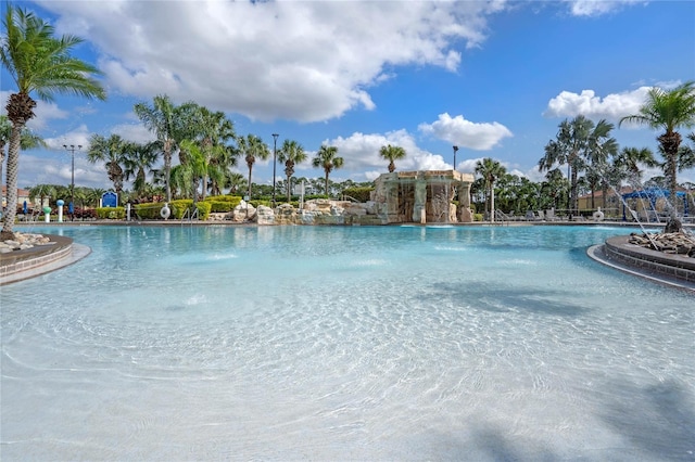 view of swimming pool with pool water feature