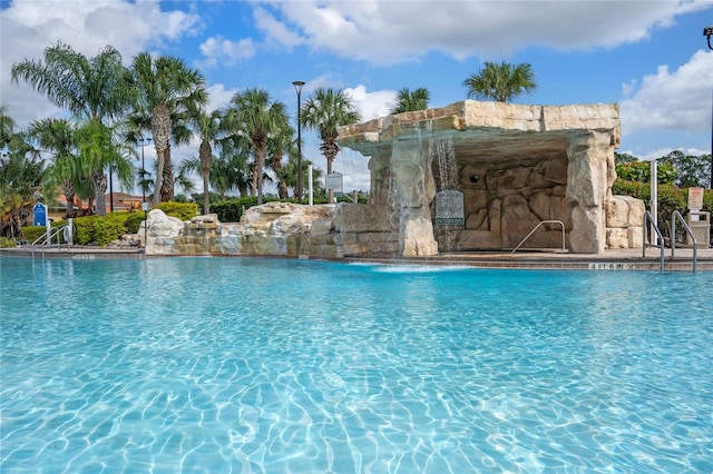 view of swimming pool featuring pool water feature