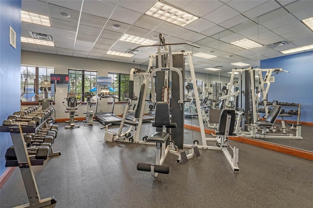 exercise room with a paneled ceiling