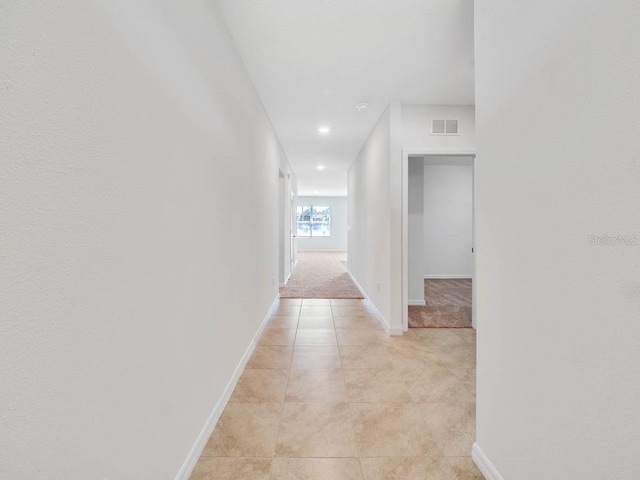 corridor with light tile patterned flooring