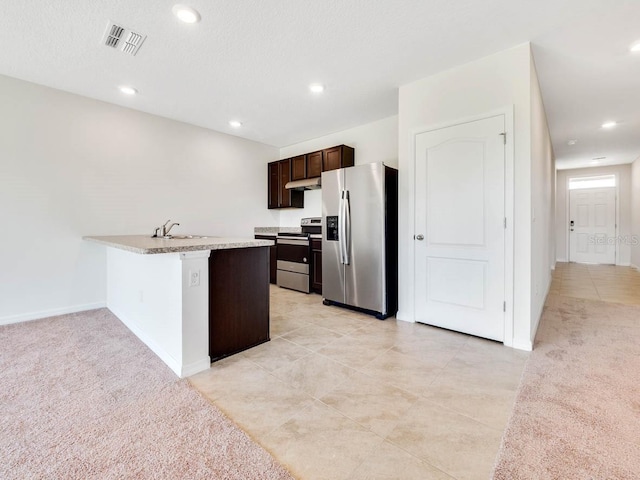 kitchen featuring sink, dark brown cabinetry, light colored carpet, kitchen peninsula, and stainless steel appliances