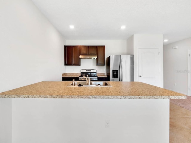 kitchen featuring sink, light tile patterned floors, an island with sink, and appliances with stainless steel finishes