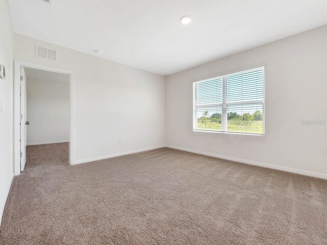 empty room with light colored carpet