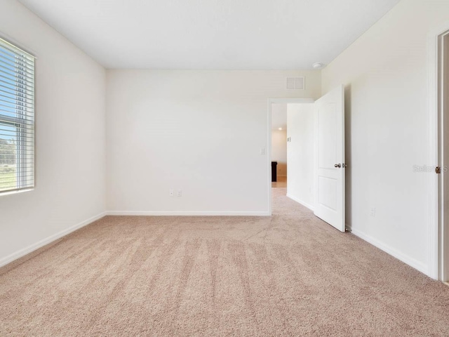 carpeted empty room with plenty of natural light