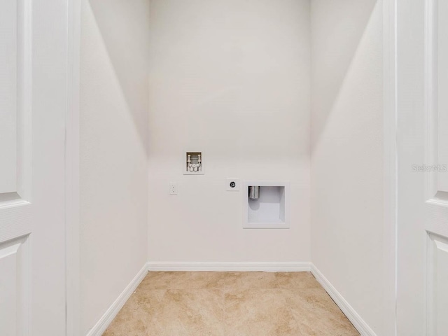 clothes washing area featuring hookup for an electric dryer, washer hookup, and light carpet