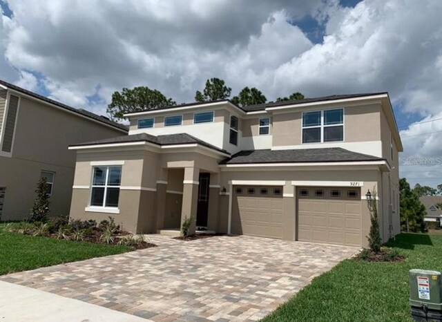 view of front of house featuring a garage and a front yard