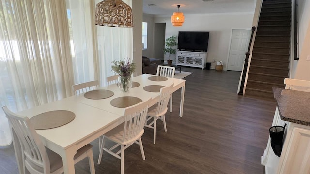 dining area with dark hardwood / wood-style floors and ornamental molding