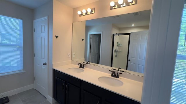 bathroom featuring tile patterned floors, vanity, an enclosed shower, and a wealth of natural light