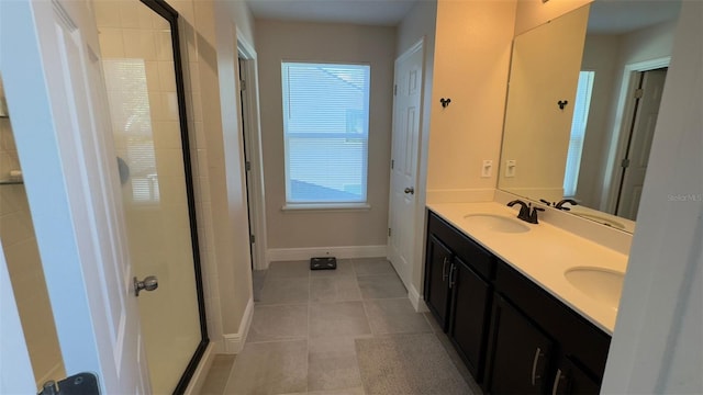 bathroom featuring tile patterned flooring, vanity, and a shower with shower door