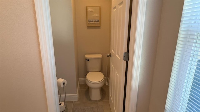 bathroom with tile patterned floors and toilet