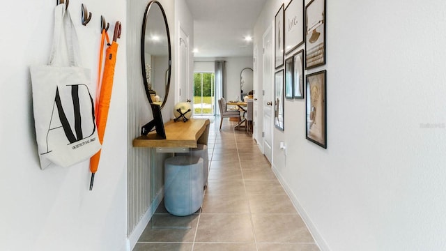 hall featuring light tile patterned flooring